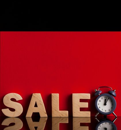 front-view-sale-word-clock-red-black-background